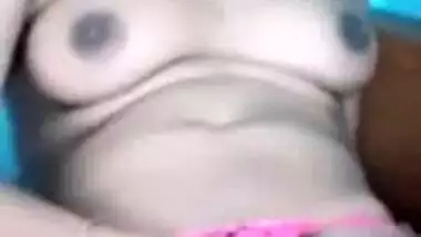 Female sits on bed exposing her XXX boobies and sex slit in Indian video