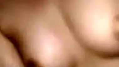 Camera films Desi teen laying XXX tits bare and touching them in bed