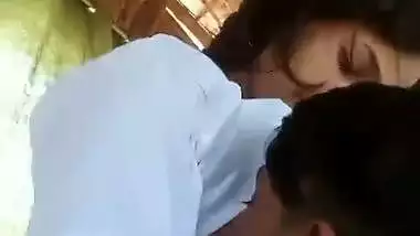 A guy presses a girl’s boobs outdoors in the local sex video
