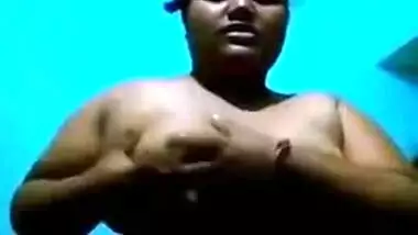 Mature Desi in a red sari exposes her big sex parts in a XXX show