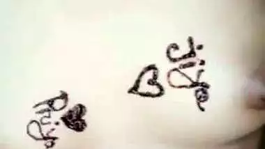 Nude girl puts henna on her naked body during a video call sex